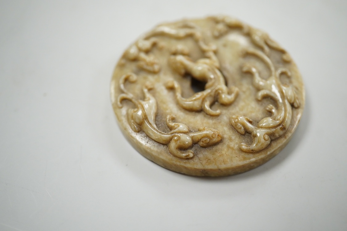 A Chinese russet jade bi disc, 5cm diameter
